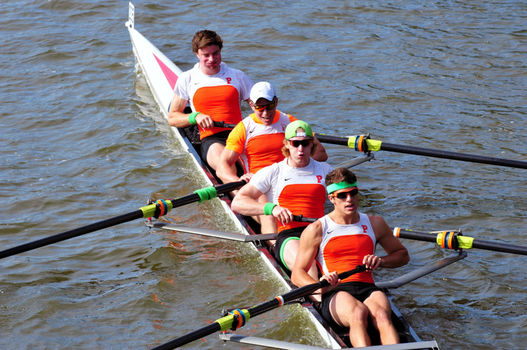 A man rowing a boat in a body of water