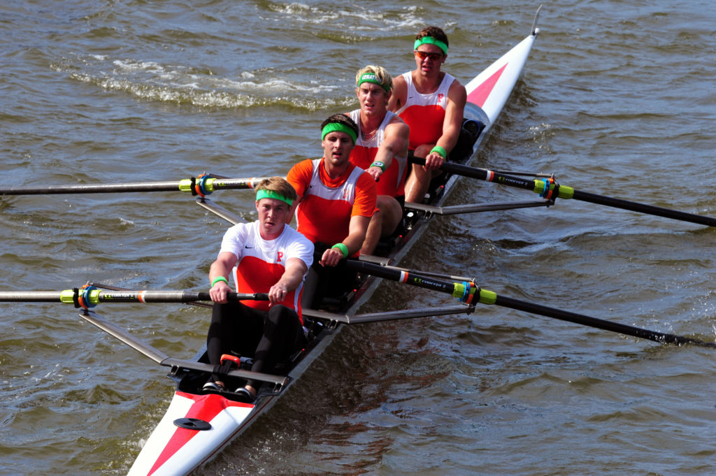 A person rowing a boat in a body of water