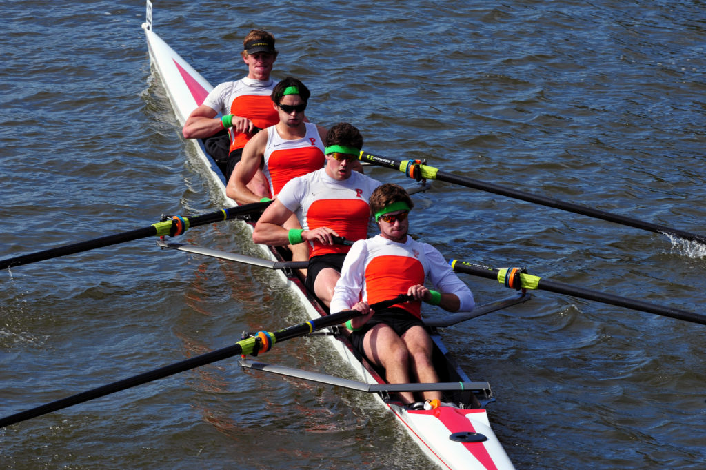 A man rowing a boat in a body of water