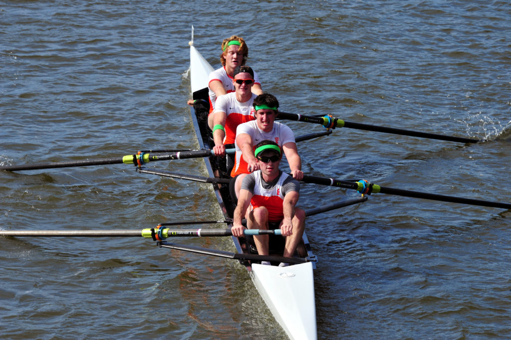 A man rowing a boat in a body of water