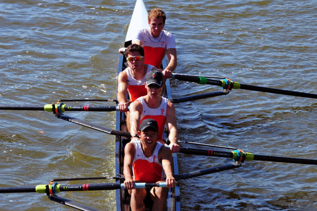 A man rowing a boat in a body of water