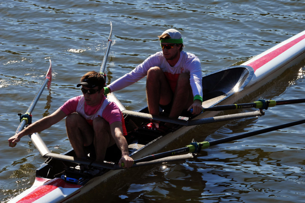 A group of people rowing a boat in the water