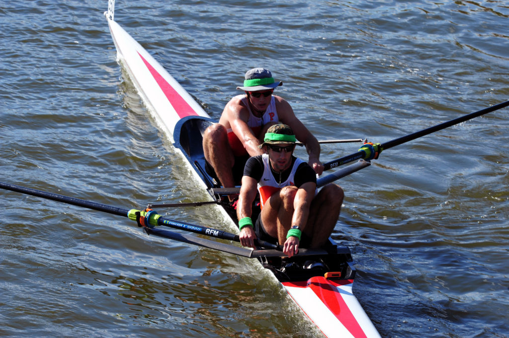 A man rowing a boat in a body of water