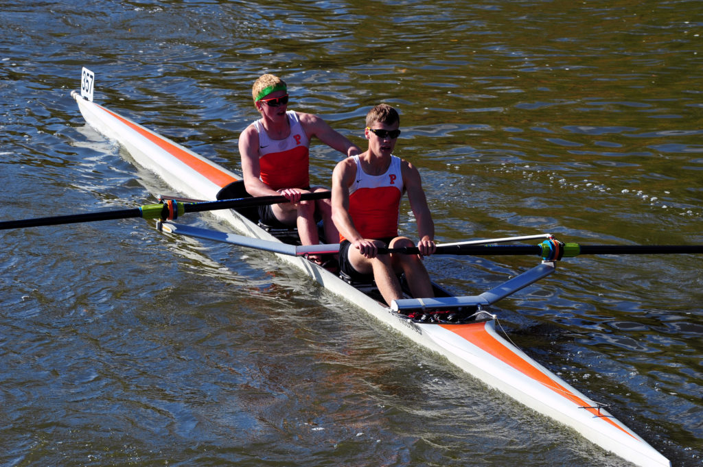 A man rowing a boat in a body of water