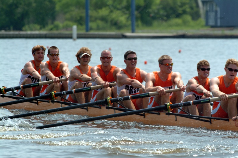 A group of people rowing a boat in the water