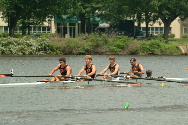 A group of people rowing a boat in the water