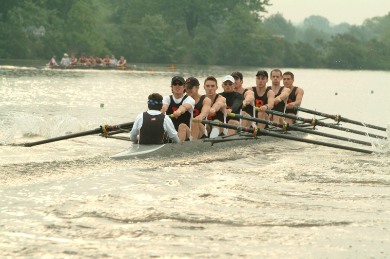 A group of people rowing a boat in the water