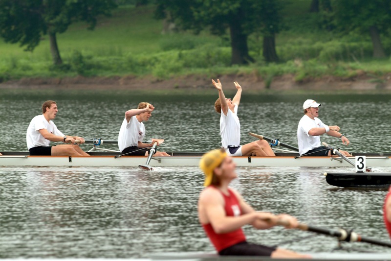 A group of people rowing a boat in a body of water