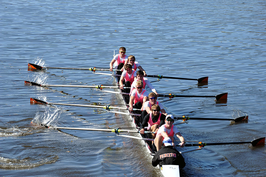 A group of people rowing a boat in the water