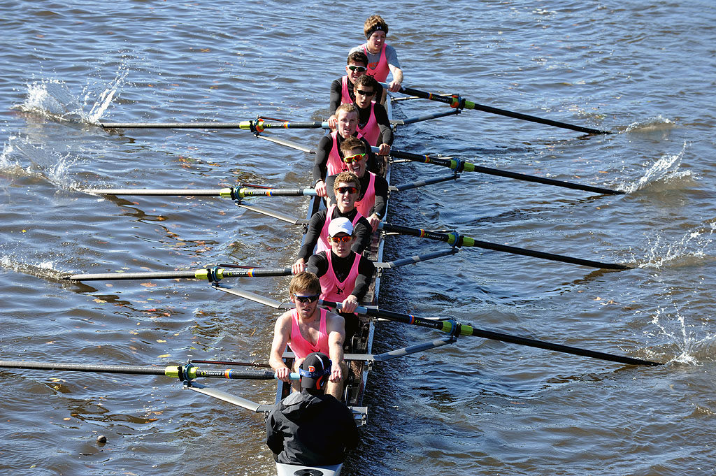 A group of people rowing a boat in the water