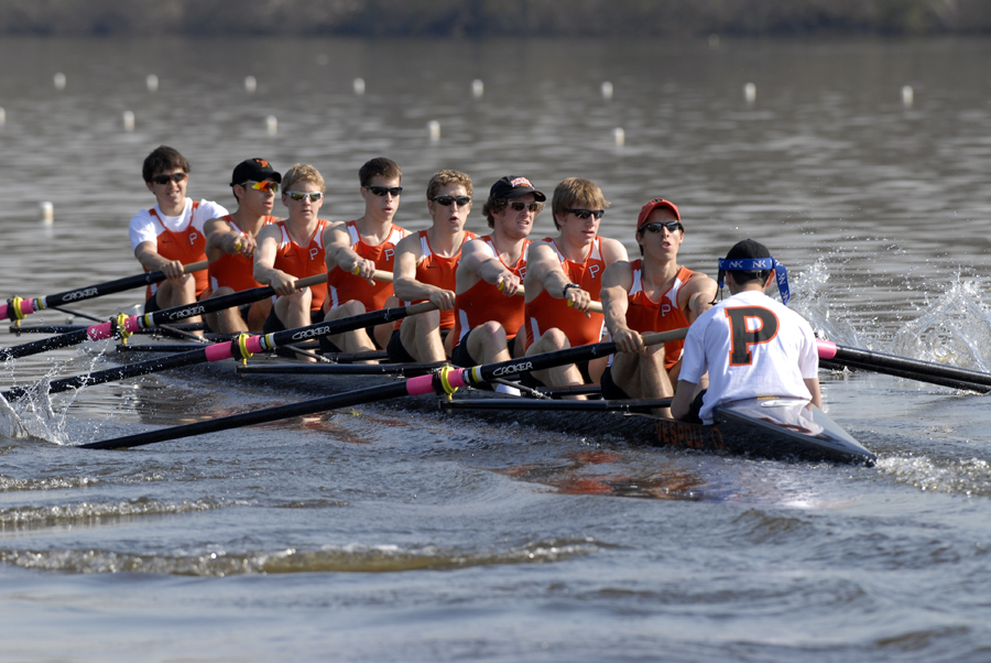 A group of people rowing a boat in the water