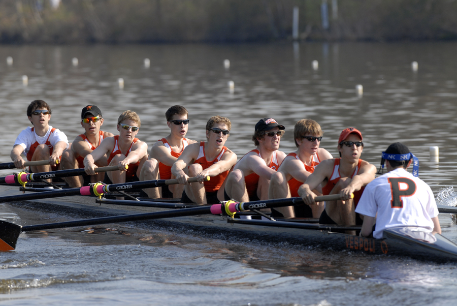 A group of people rowing a boat in the water