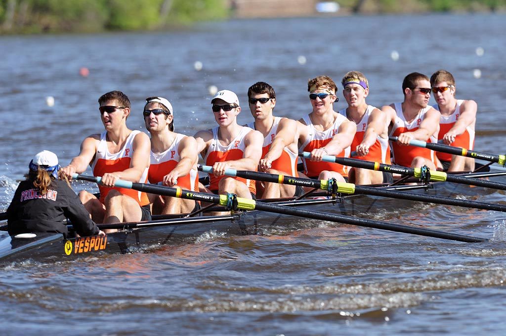 A group of people rowing a boat in the water