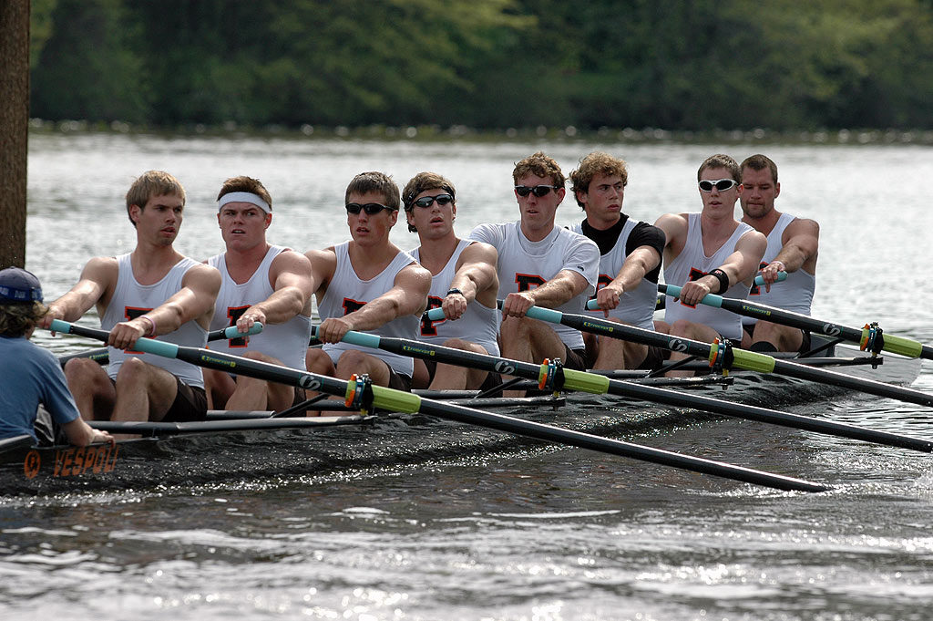 A group of people rowing a boat in the water