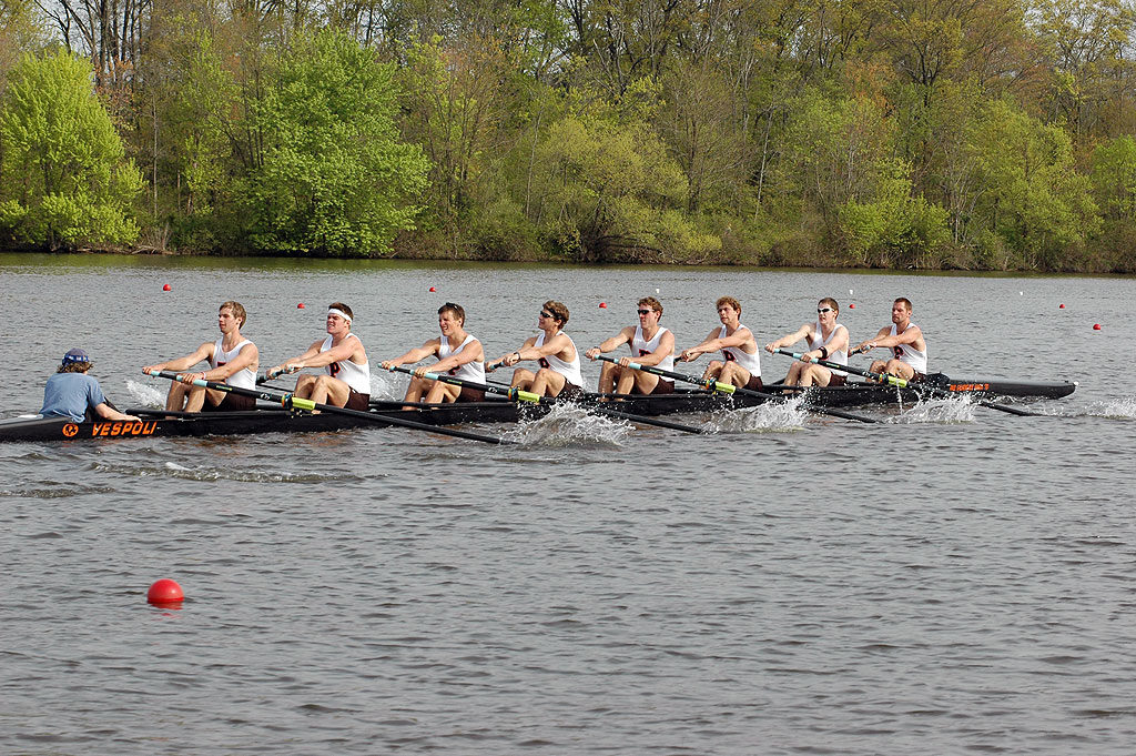 A group of people rowing a boat in the water