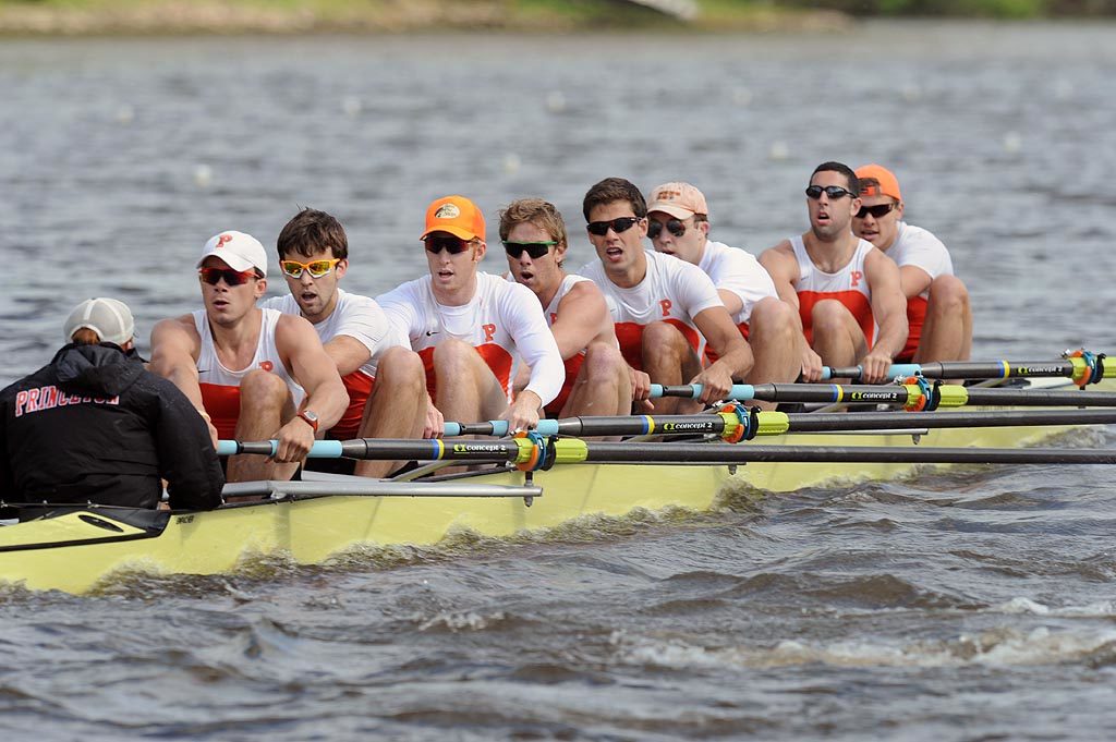 A group of people rowing a boat in the water