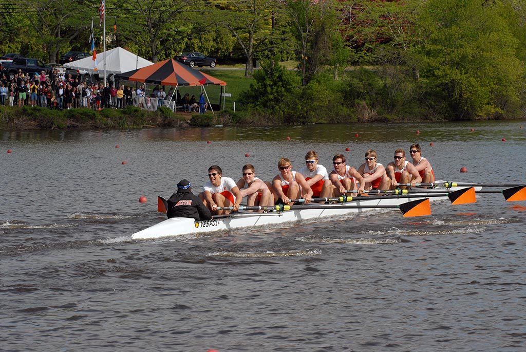 A group of people rowing a boat in the water