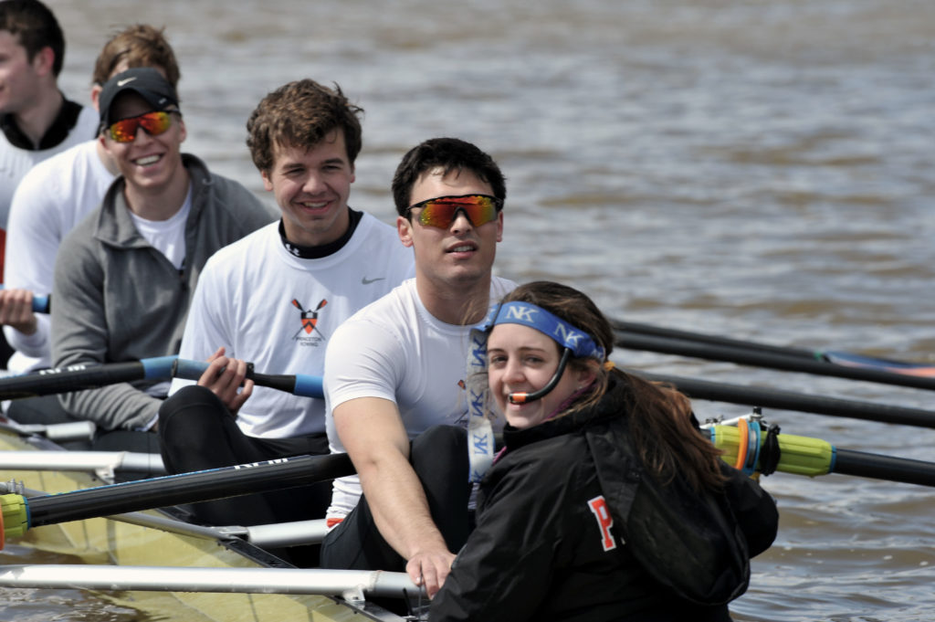 A group of people rowing a boat in the water