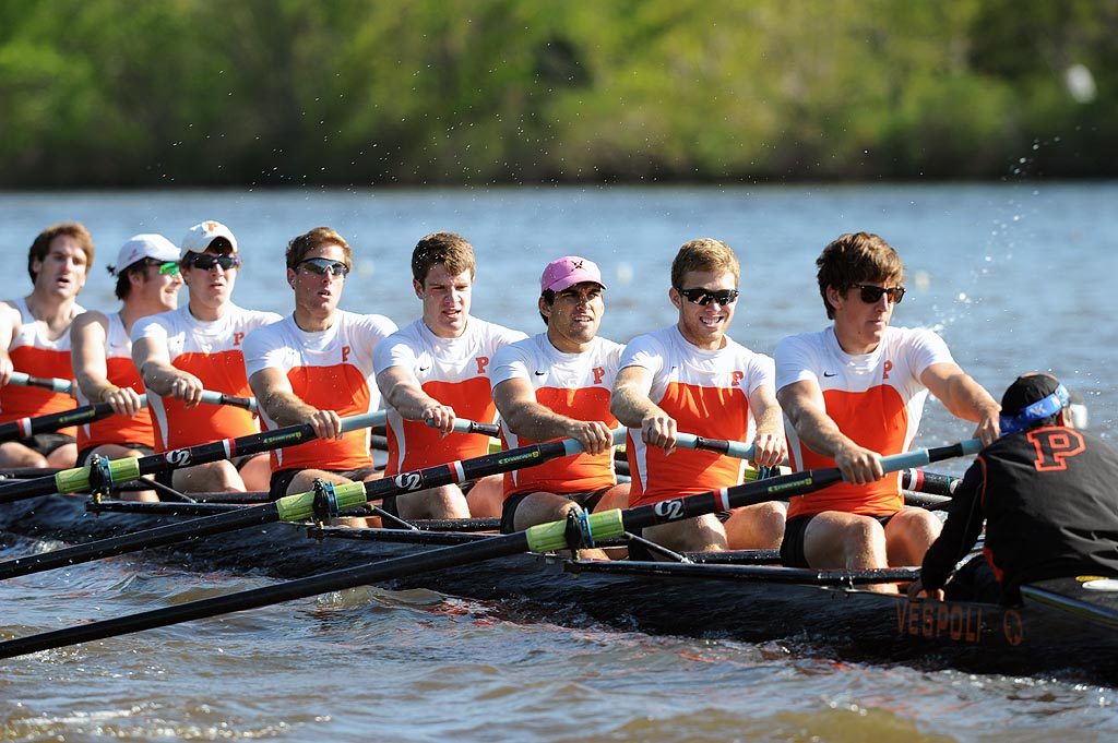 A group of people rowing a boat in the water