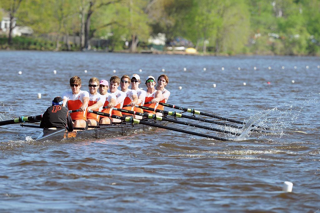 A group of people rowing a boat in the water