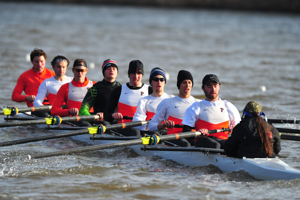 A group of people rowing a boat in the water