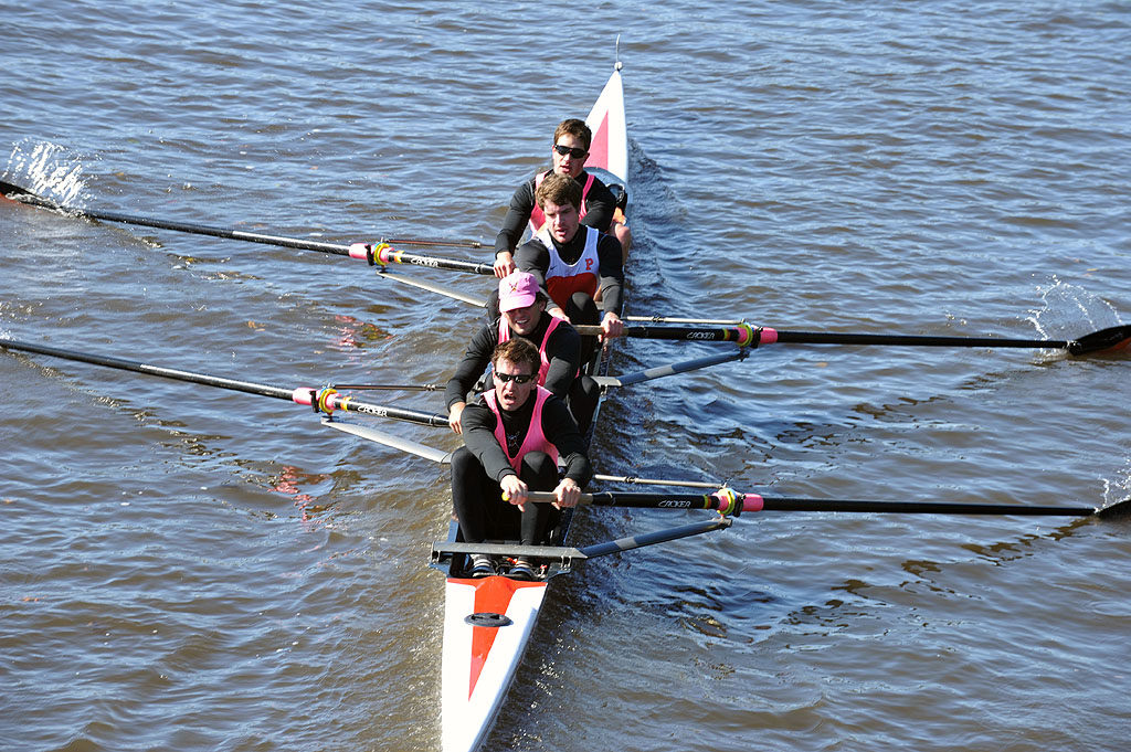 A group of people rowing a boat in the water