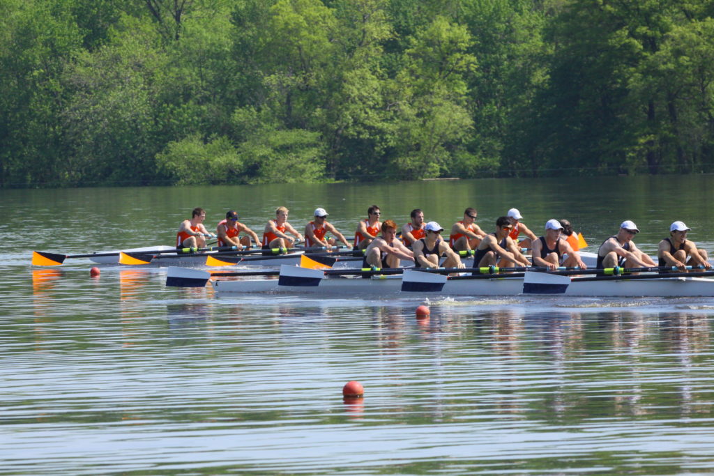 A group of people rowing a boat in the water