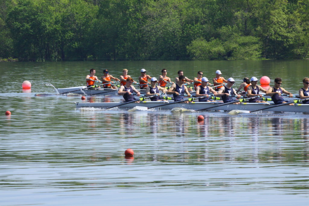 A group of people rowing a boat in the water