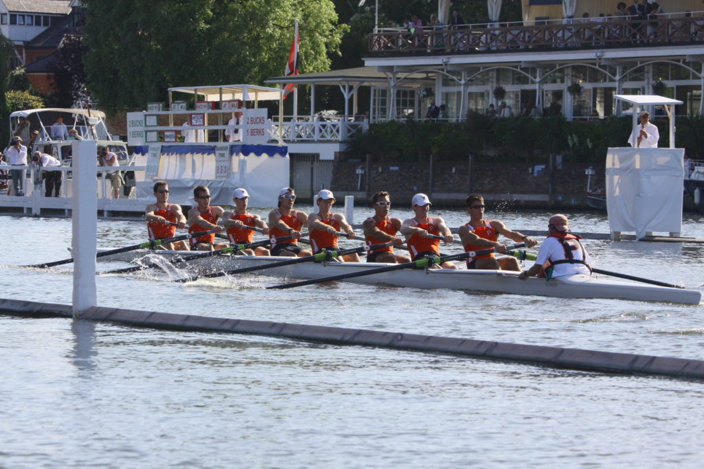 A group of people rowing a boat in the water