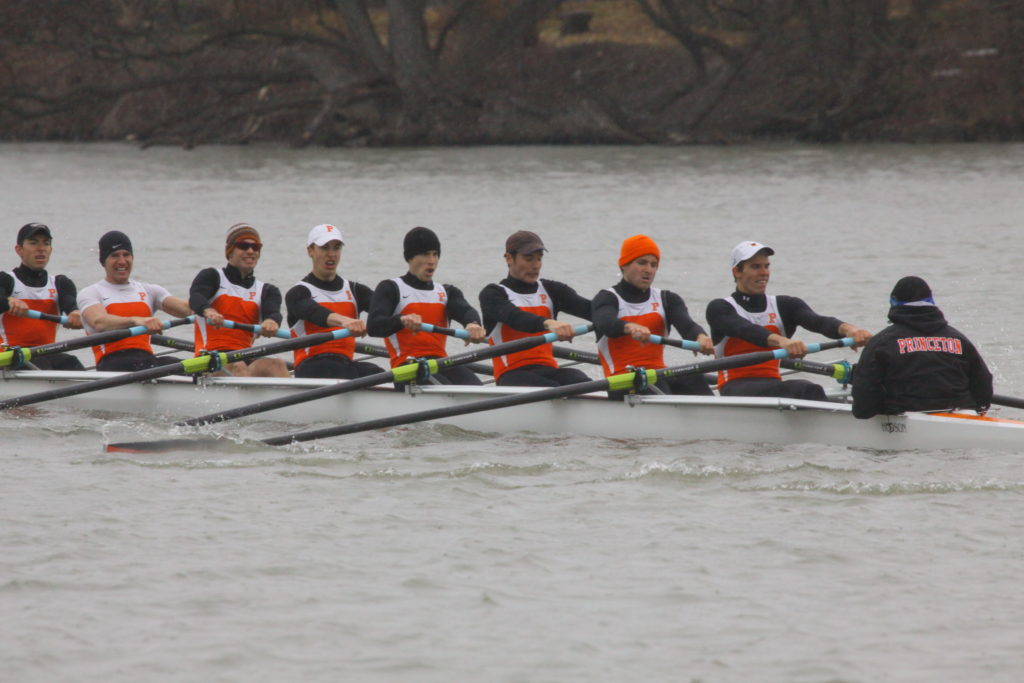 A group of people rowing a boat in the water