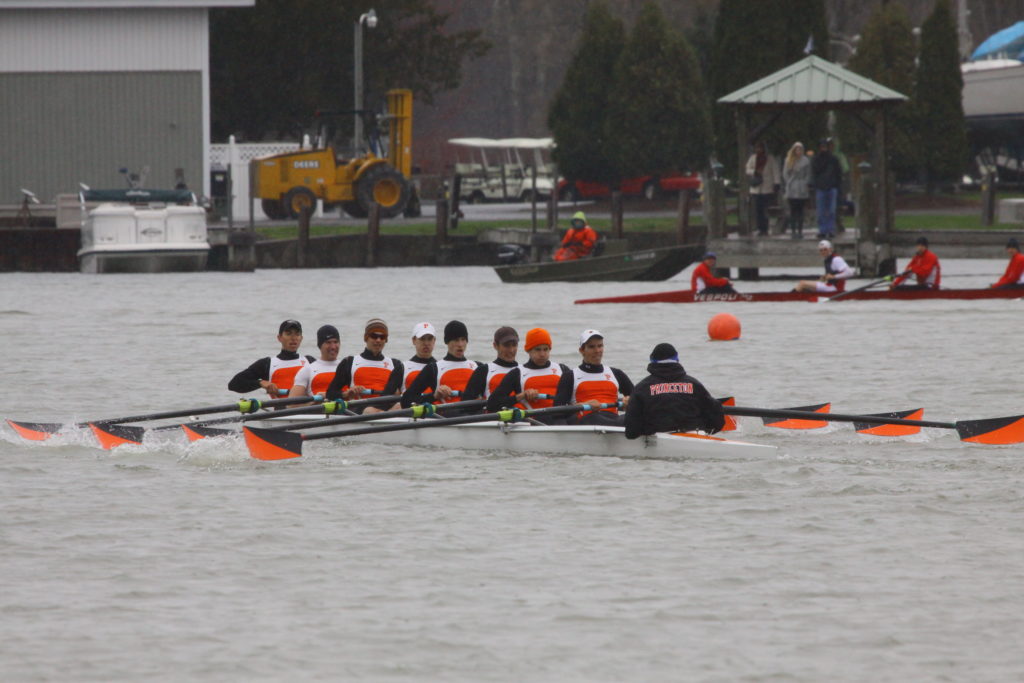 A group of people rowing a boat in the water