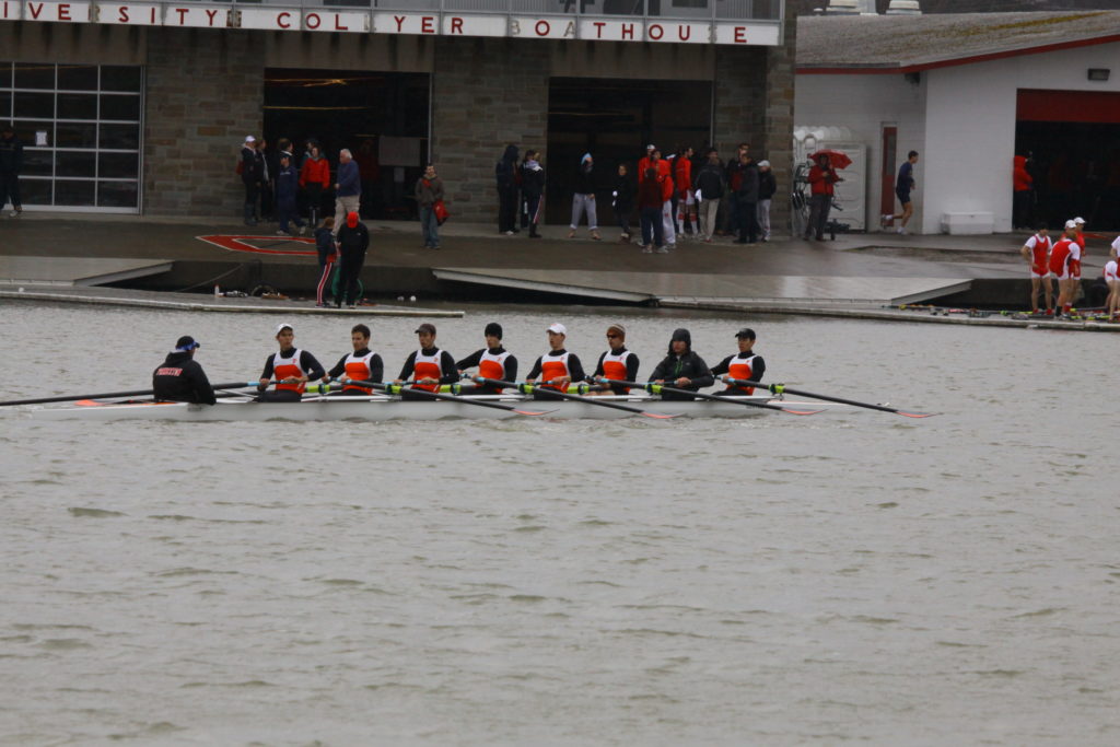 A group of people rowing a boat in the water