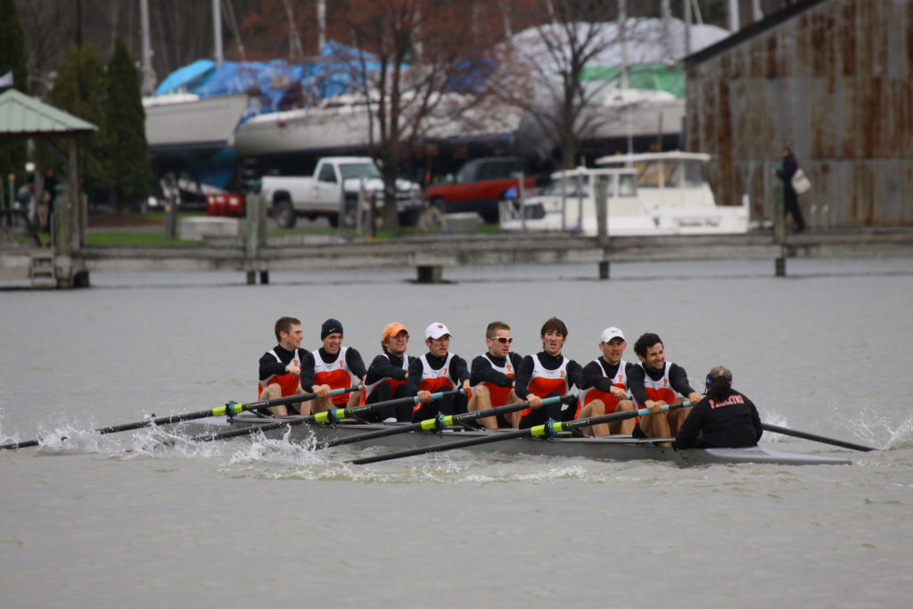 A group of people rowing a boat in the water