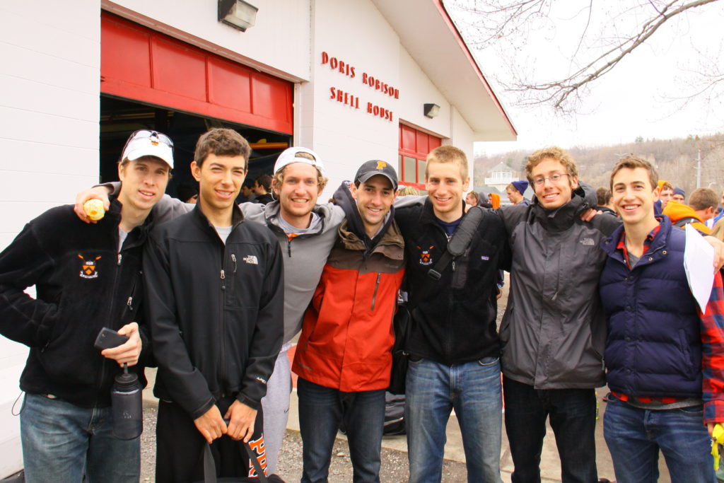 A group of people standing in front of a crowd posing for the camera