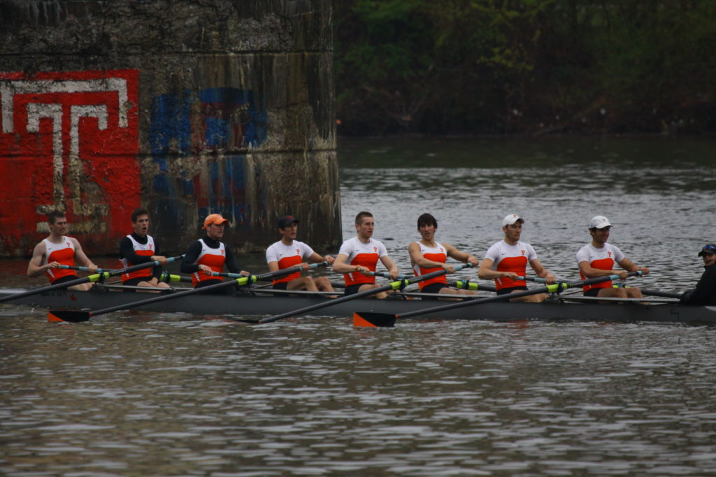 A group of people rowing a boat in the water