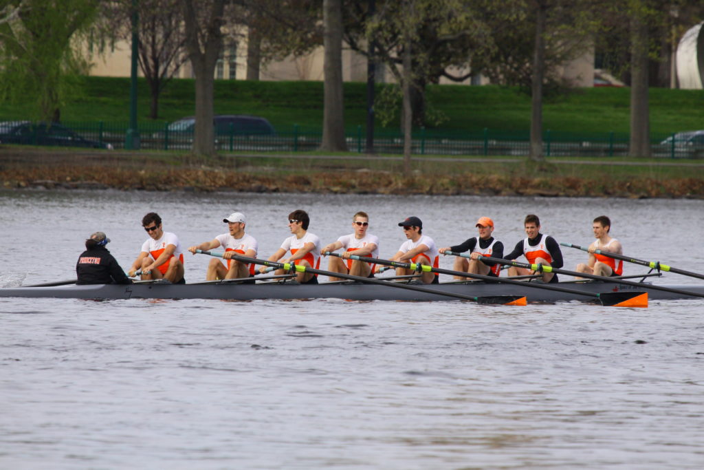 A group of people rowing a boat in the water