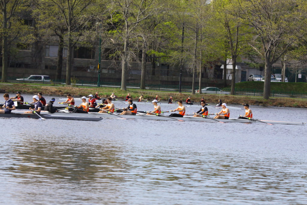 A group of people rowing a boat in the water