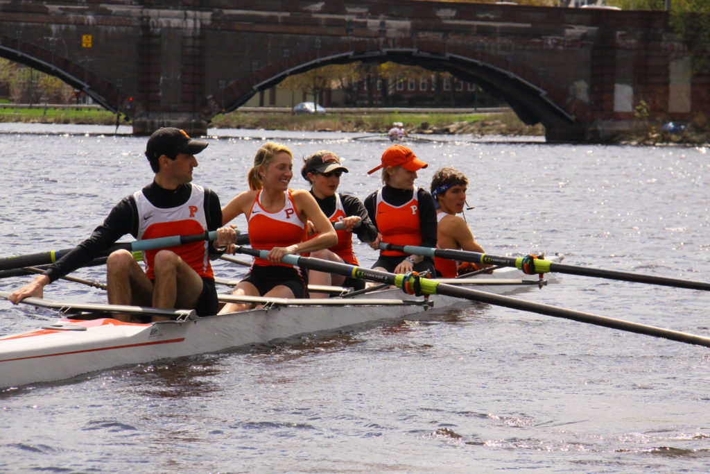 A group of people rowing a boat in the water