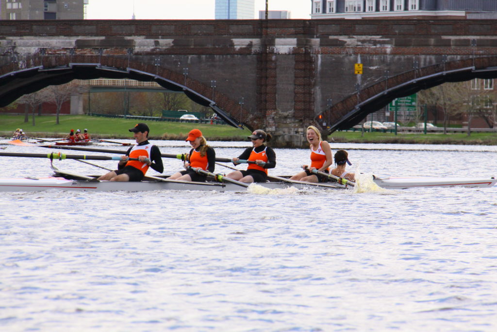 A group of people rowing a boat in the water