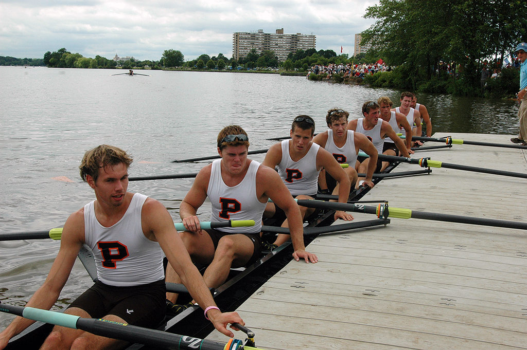 A group of people rowing a boat in the water