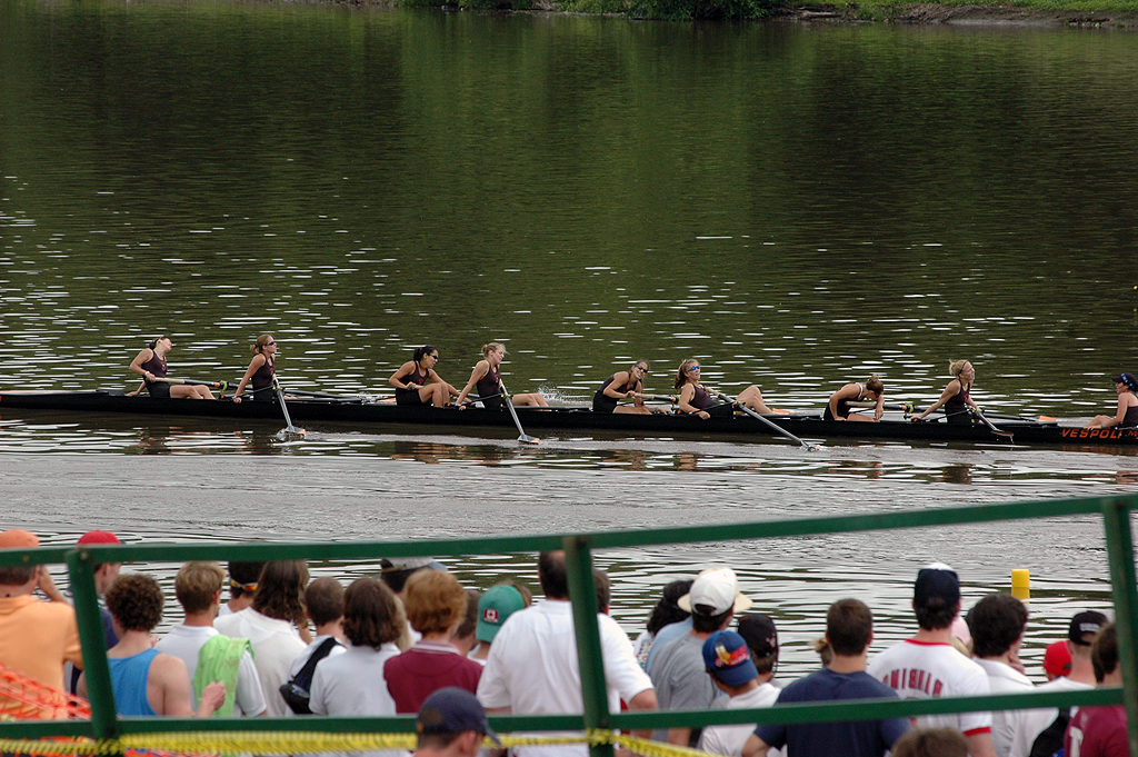 A group of people rowing a boat in the water