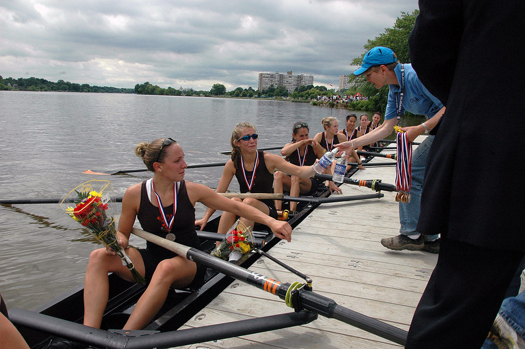 A group of people rowing a boat in the water