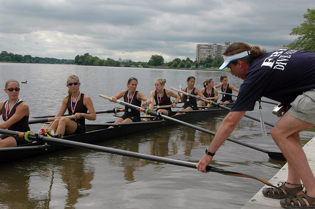 A group of people rowing a boat in the water