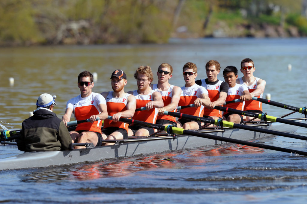 A group of people rowing a boat in the water