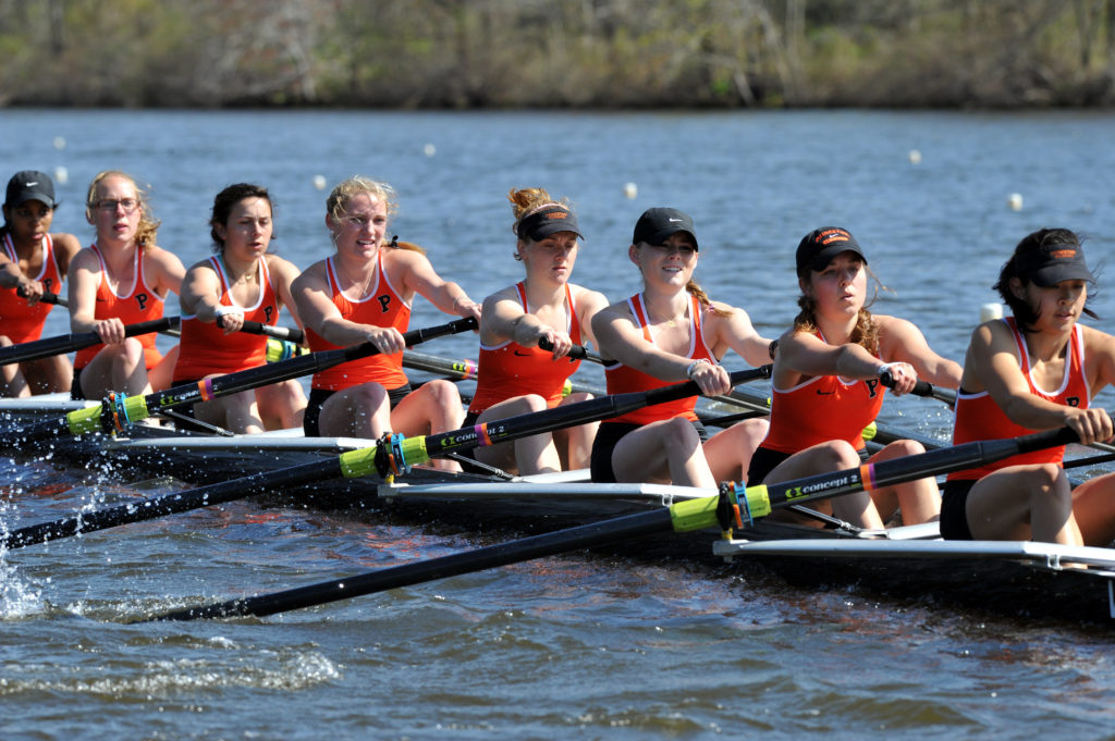 A group of people rowing a boat in the water