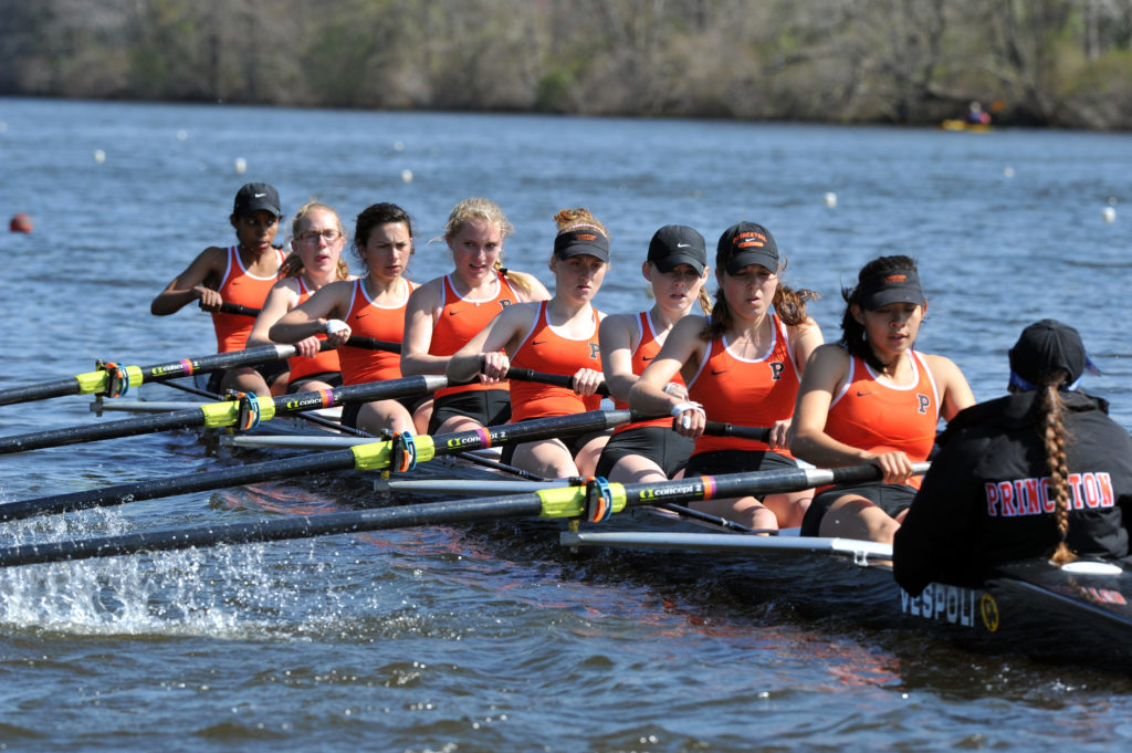 A group of people rowing a boat in the water