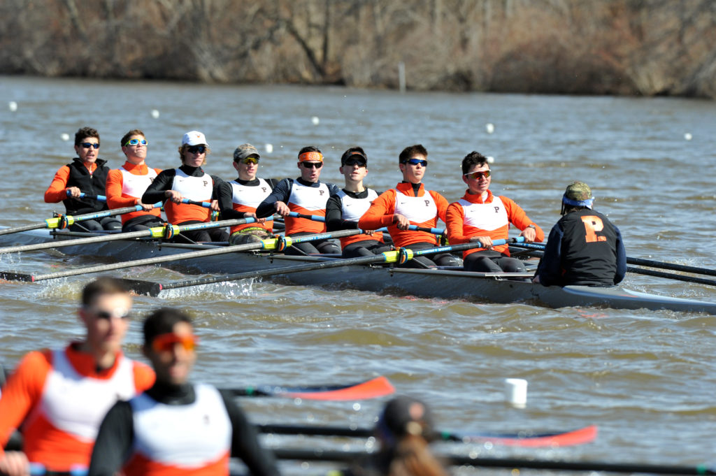 A group of people rowing a boat in the water