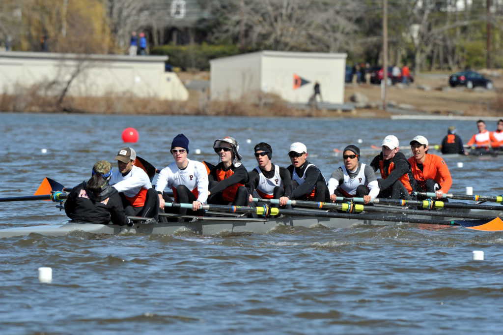 A group of people rowing a boat in the water