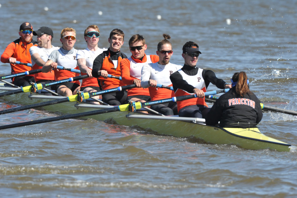 A group of people rowing a boat in the water