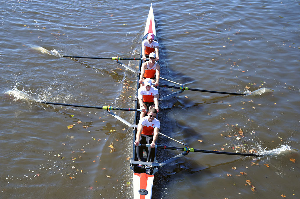 A person rowing a boat in a body of water